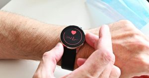Smartwatch showing a heart rate reading, illustrating heart health beyond cholesterol