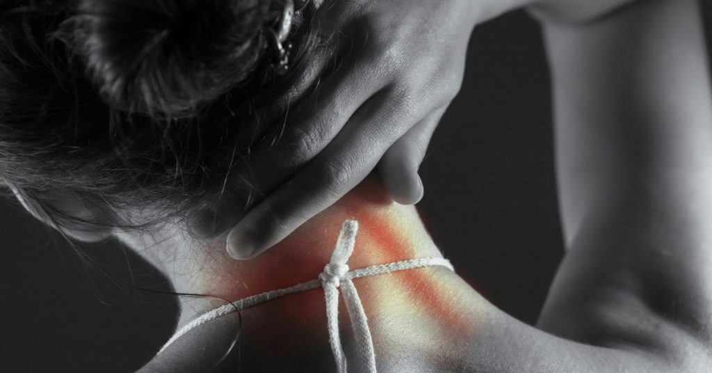 Woman holding her neck in discomfort, illustrating joint comfort and inflammation